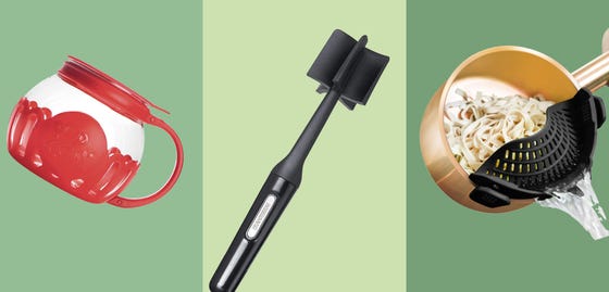 A kitchen with green cabinets and a white countertop.