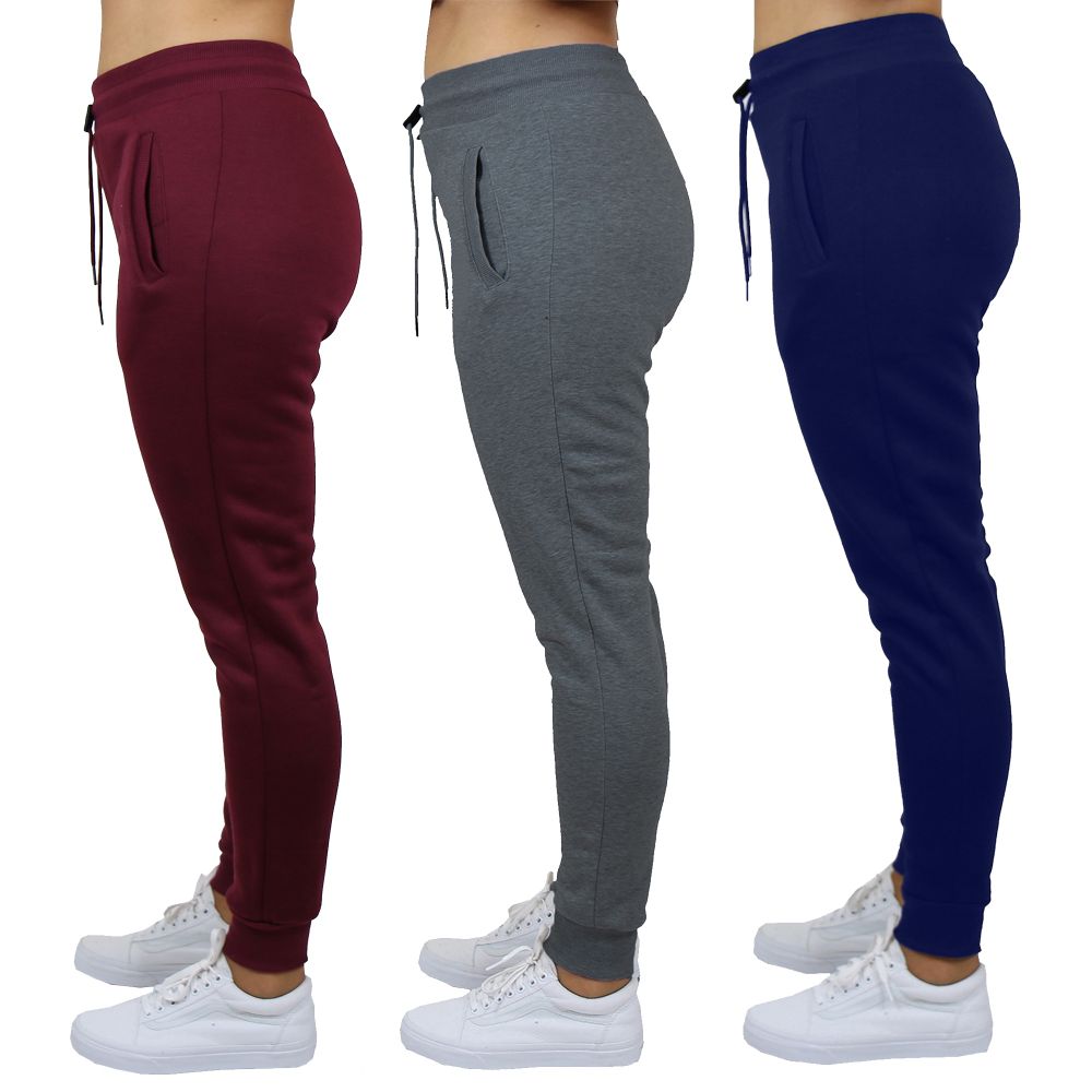 Three pairs of jogger pants in burgundy, gray, and navy, each worn with white sneakers.