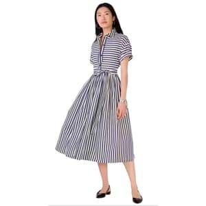 A woman is wearing a striped, short-sleeve, belted midi dress paired with black flats.
