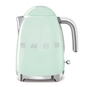 A light green SMEG electric kettle featuring a retro design with a chrome handle and spout, and the brand name prominently displayed on the side.