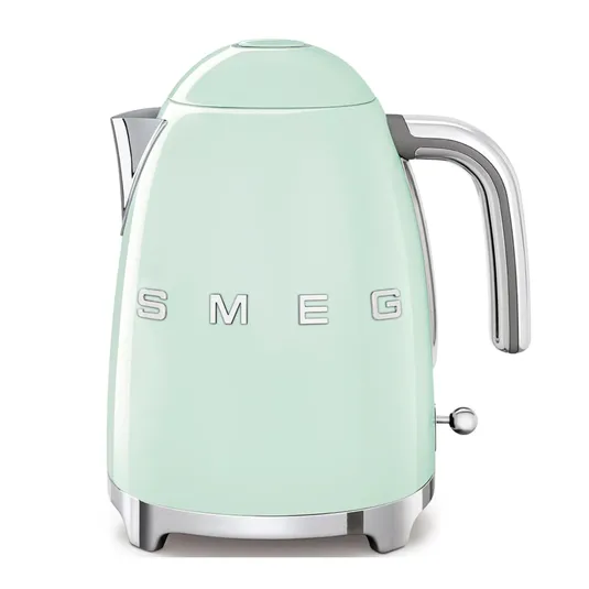 A light green SMEG electric kettle featuring a retro design with a chrome handle and spout, and the brand name prominently displayed on the side.
