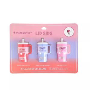 The Taste Beauty Lip Sips 3-Pack features flavored lip balms shaped like tumblers, including Mango Dragon Fruit, Hibiscus Pomegranate, and Paradise Punch. Total weight is 0.54 oz (15 g).