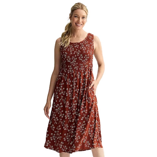 Sleeveless knee-length dress in a rust color with a white floral print, featuring a round neckline and fitted bodice.