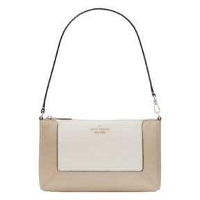A two-tone beige and cream leather shoulder bag with a short strap, featuring the Kate Spade New York logo on the front.