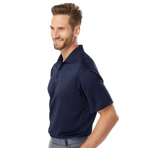 A man is wearing a navy blue Adidas polo shirt with short sleeves and a collar, featuring a three-button placket and the Adidas logo on the chest.