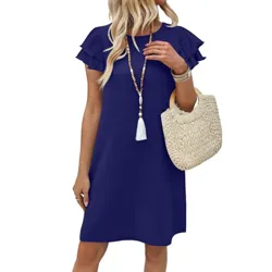 A woman is wearing a short-sleeve, ruffled navy blue dress, accessorized with a long beaded necklace and carrying a woven straw handbag.