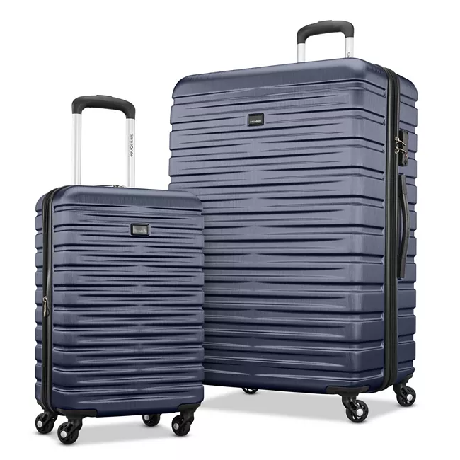 The 2-piece Samsonite Hardside Spinner Set includes a large and a carry-on suitcase, both in a blue color with a textured horizontal stripe pattern. They feature retractable handles and multi-directional spinner wheels for easy maneuverability.
