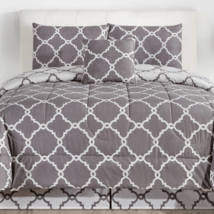 A gray and white comforter set featuring a geometric lattice pattern, including a comforter, two pillow shams, and a decorative pillow.