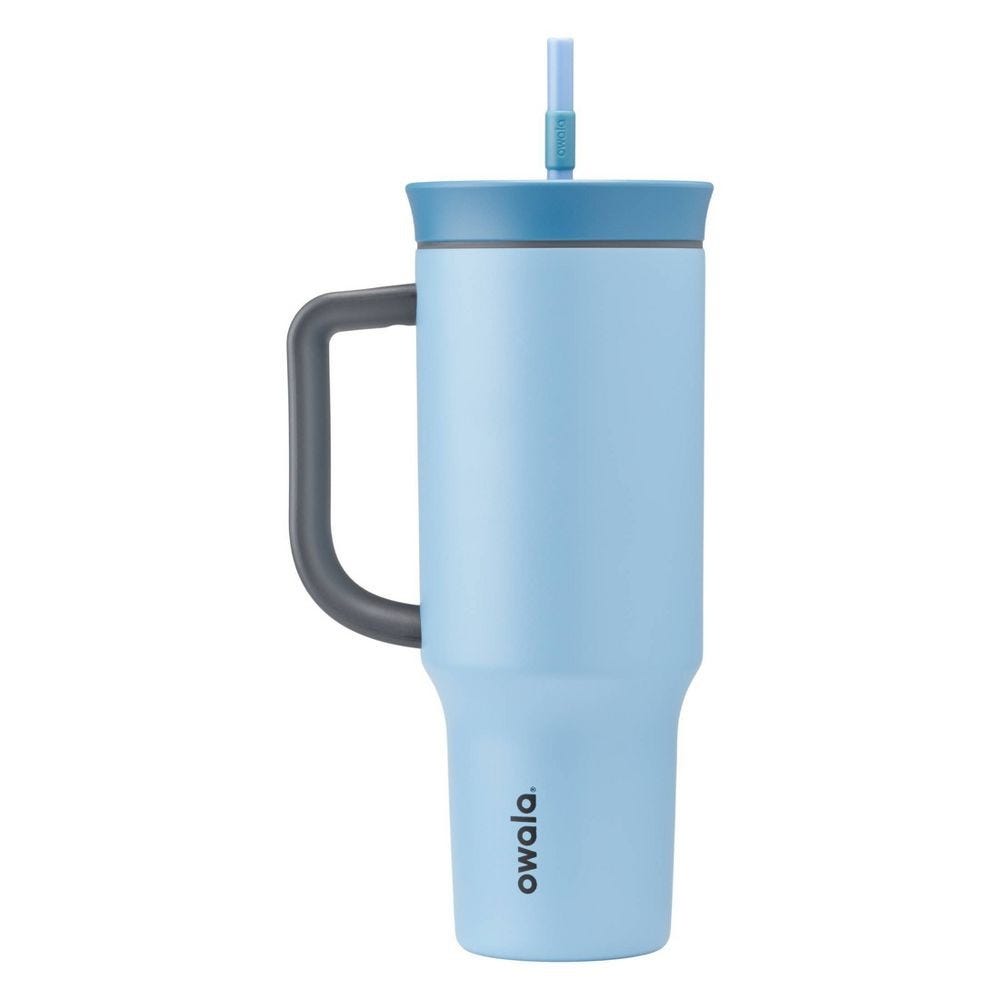 A light blue Owala travel mug with a handle, lid, and integrated straw.