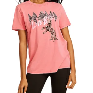 Pink T-shirt featuring \“Def Leppard Love Bites\“ text and a leopard graphic, paired with black leggings.
