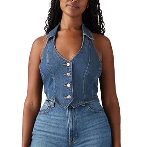Levi's Denim Corset Cropped Top features a sleeveless design with a halter neckline, button-up front, and tailored seams in medium blue denim, offering a fitted and stylish look paired with high-waisted jeans.