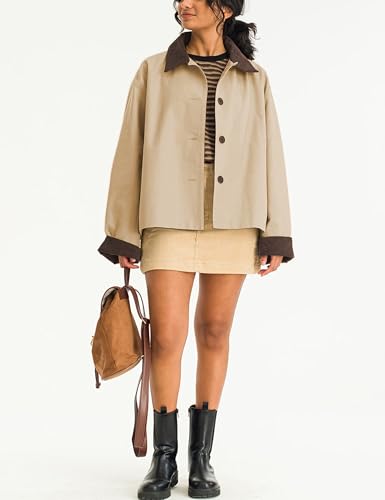 A person is wearing a beige jacket with a dark collar, a striped top, a beige mini skirt, and black boots, accessorized with a brown backpack.