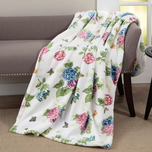 A floral-patterned blanket draped over a chair.