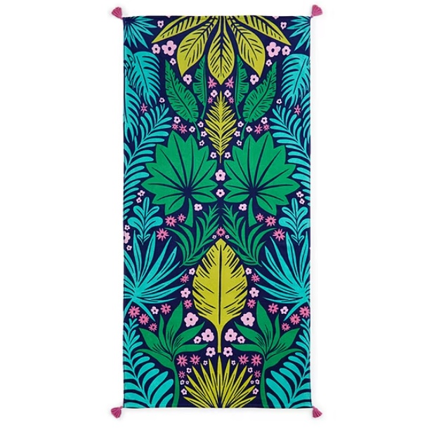 A colorful rectangular towel with a vibrant tropical leaf pattern featuring shades of green, blue, yellow, and pink on a dark blue background, accented with pink tassels at each corner.