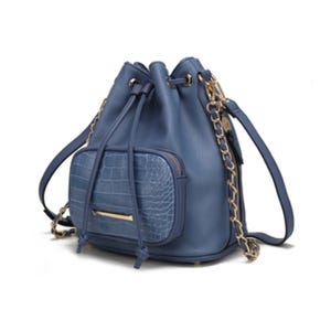 A blue drawstring bucket bag with a faux crocodile texture pocket, featuring gold chain accents and an adjustable shoulder strap.