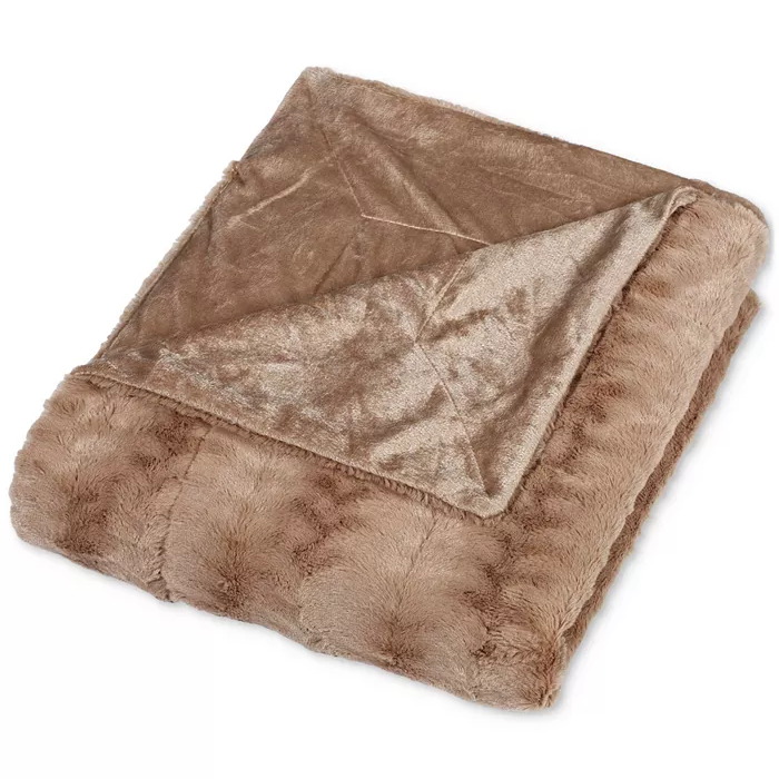 A folded brown faux fur throw blanket with a soft, plush texture, showcasing a smooth inner lining.