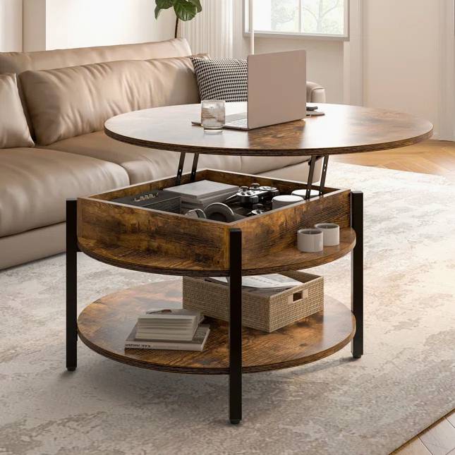Round lift-top coffee table with a rustic wood finish, featuring internal storage and a lower shelf. The table's elevated top is used for holding a laptop and drink, while the storage compartment contains various items and the shelf holds books and a basket.