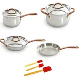 A set of stainless steel cookware including a saucepan with lid, stockpot with lid, sauté pan with lid, skillet, and three red silicone spatulas with wooden handles.