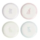 Set of four ceramic plates featuring pastel-colored rabbits and floral patterns, each with a scalloped border in pink, yellow, blue, and purple.