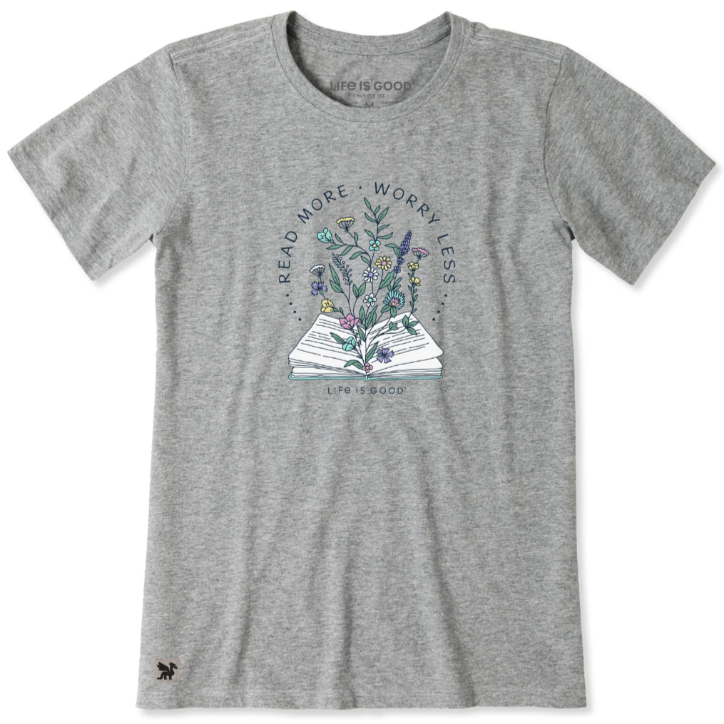 Gray T-shirt with a design of an open book with flowers and the text \“READ MORE, WORRY LESS\“ and \“LIFE IS GOOD.\“