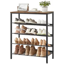 A black metal shoe rack holds assorted footwear, including sneakers, heels, and boots, with a wood top displaying a plant, a small photo frame, and a box.