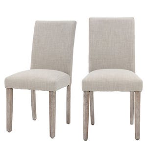 Two beige upholstered dining chairs with wooden legs and a simple, modern design.