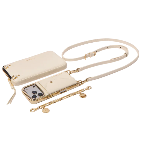 Cream-colored phone case with strap, zippered pouch, and chain accessory, featuring gold accents and hardware.