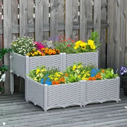A tiered garden planter with a wicker-style design, featuring a variety of colorful flowers arranged in three sections. Placed on a wooden deck against a wooden fence.