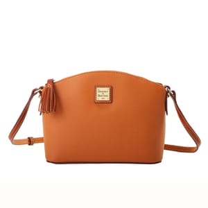 Dooney & Bourke Leather Crossbody in a light brown hue with a curved top, featuring a tassel detail, gold-tone logo plate, and an adjustable crossbody strap.