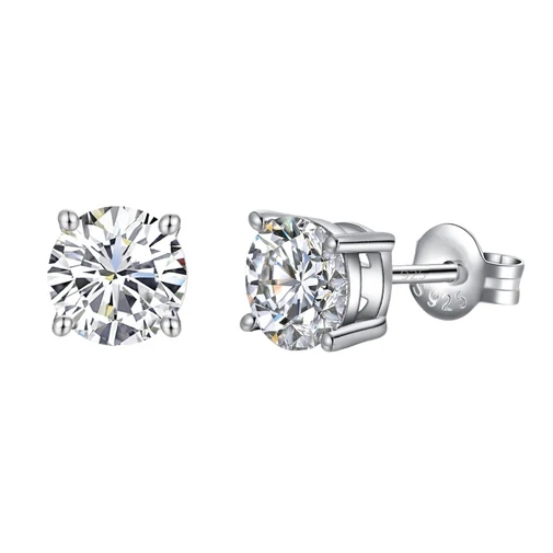 A pair of round-cut, silver-tone stud earrings with clear stones, featuring a four-prong setting and a 925 sterling silver mark on the backing.