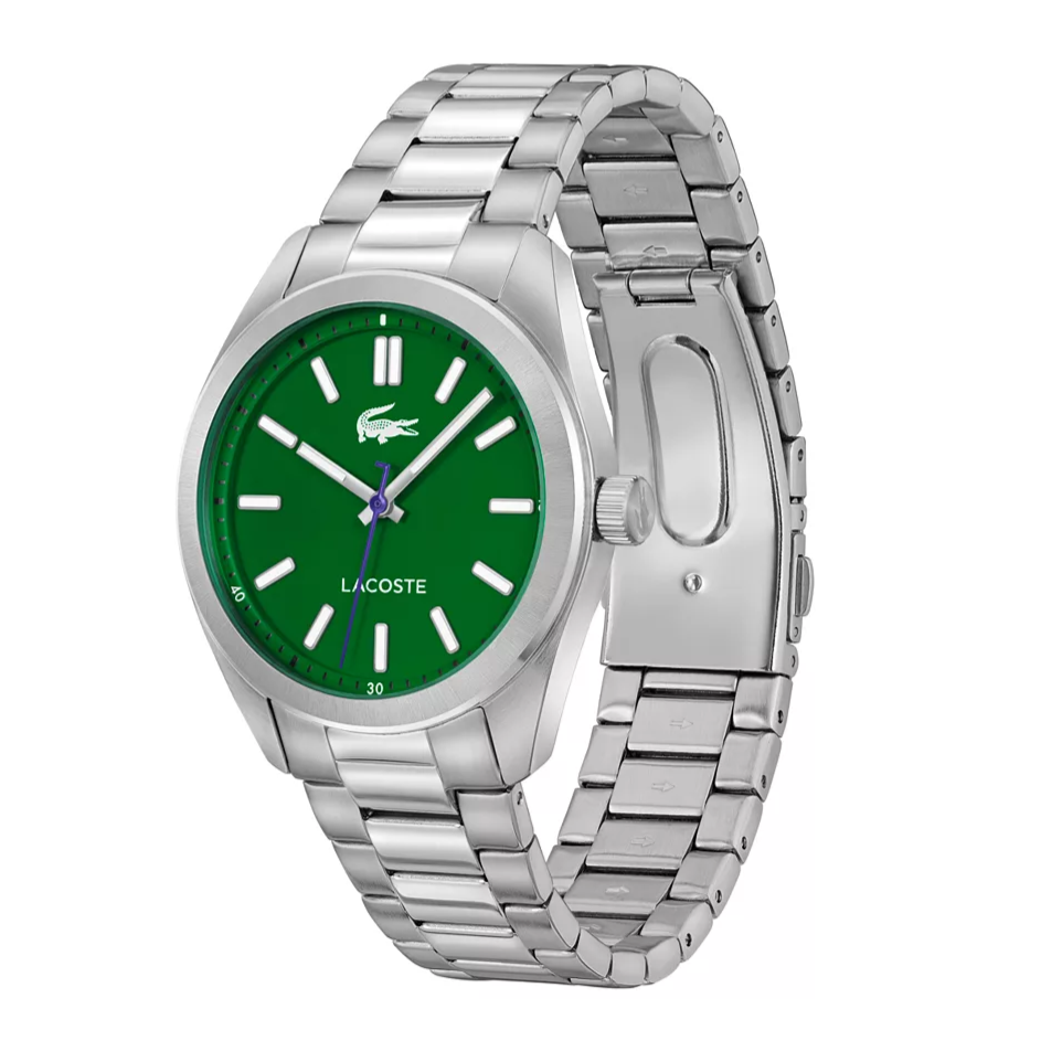 A silver stainless steel watch with a green dial featuring white hour markers and a Lacoste logo. The bracelet is polished with a clasp closure.