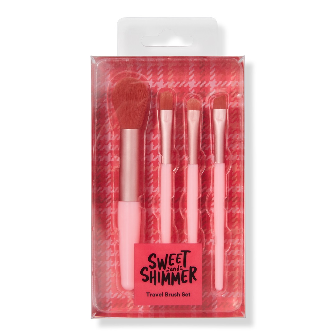 A set of four pink makeup brushes for travel, including various brush types for makeup application, packaged in a clear plastic case with a red cushioned backing.