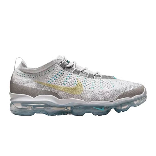 Nike Air VaporMax features a sleek, low-top design with a white and gray knit upper, transparent Air cushioning soles, and a subtle yellow Swoosh logo.