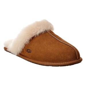 A tan UGG slipper with a sheepskin lining and suede exterior, featuring an open back design.