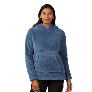 A person wearing a blue, plush fleece pullover hoodie with a front pocket, paired with black pants.