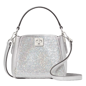 Kate Spade Phoebe Glitter Crossbody features a sparkling silver glitter finish with a top handle, adjustable strap, and a silver turn-lock closure.