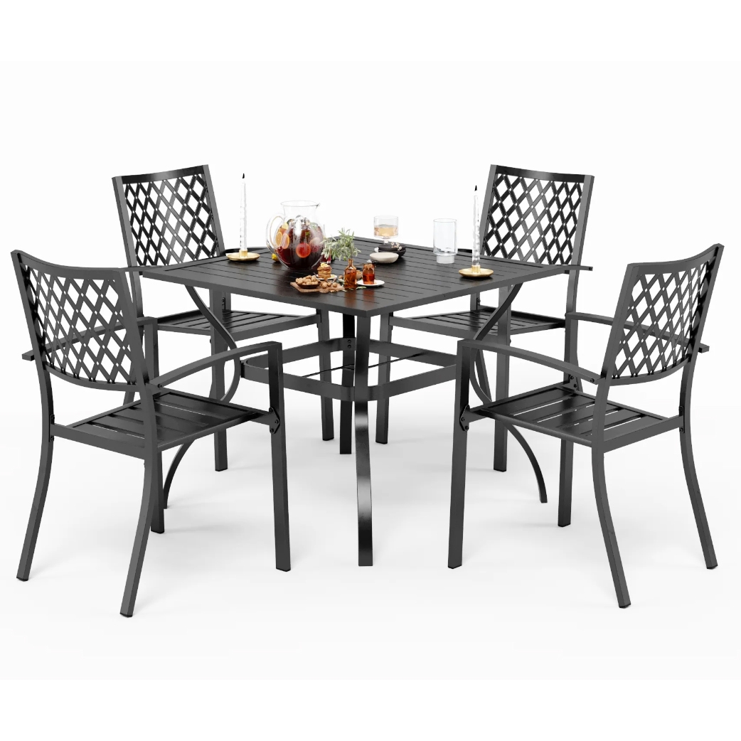 5-piece steel patio dining set with a square table and four chairs featuring lattice-patterned backs and slatted seats, in a dark finish. The table is set with a pitcher, glasses, candles, and small dishes.
