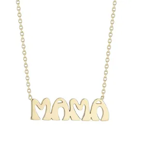 A gold necklace with the word \“MAMA\“ crafted in stylized letters hanging from a delicate chain.