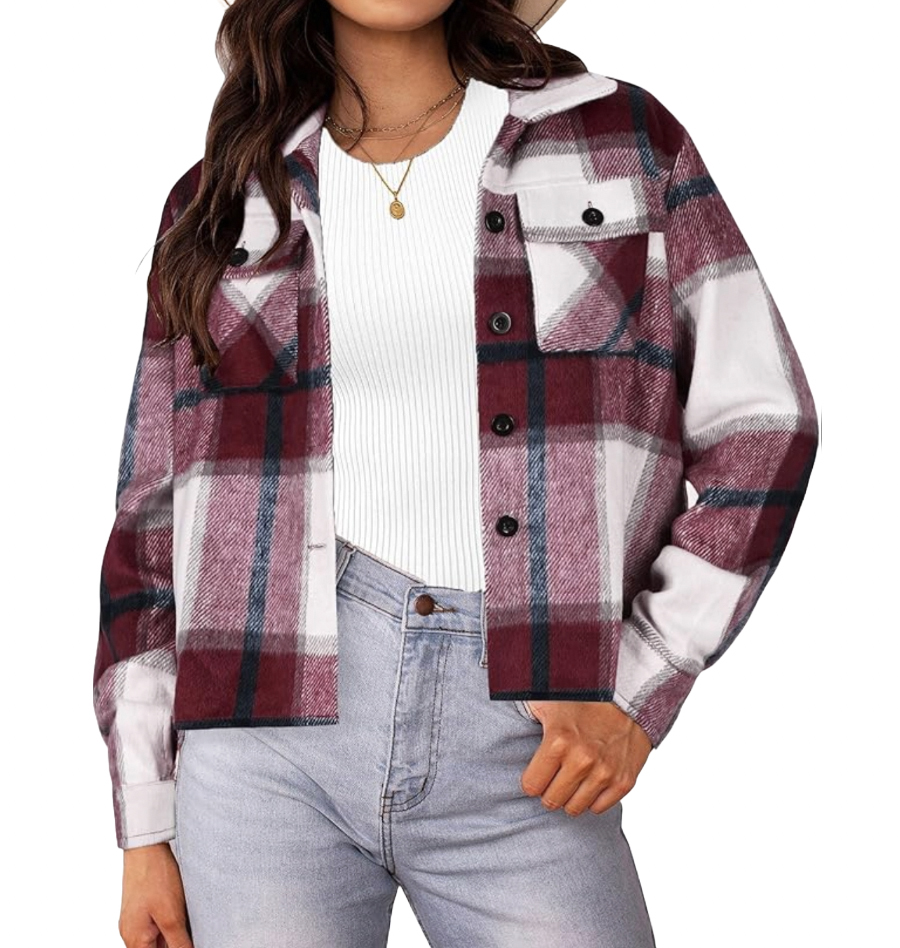 A women's cropped shacket featuring a burgundy, black, and white plaid pattern. It has a button-up front, chest pocket, and is paired with a white ribbed top and light blue jeans.