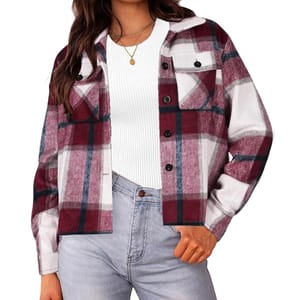 A women's cropped shacket featuring a burgundy, black, and white plaid pattern. It has a button-up front, chest pocket, and is paired with a white ribbed top and light blue jeans.