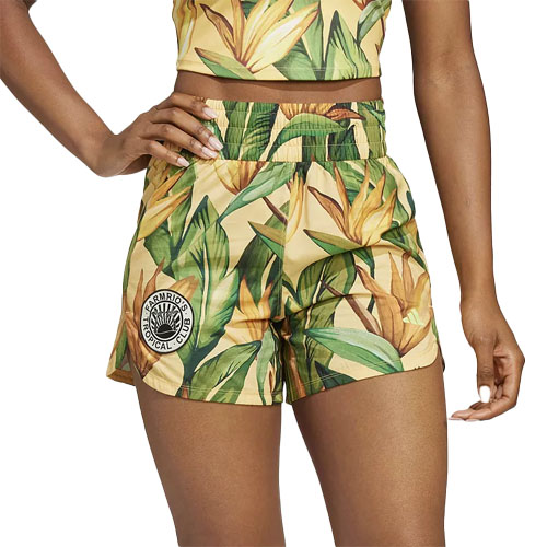 Adidas x Farm Rio Training Shorts feature a vibrant tropical leaf and flower print with a small circular logo on the left side. They have an elastic waistband and are designed for comfort and style.