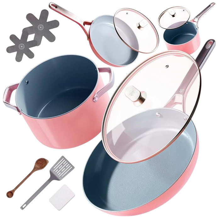 A pink cookware set including various pots and pans with lids, a wooden spoon, metal spatula, and two protective pads for stacking.