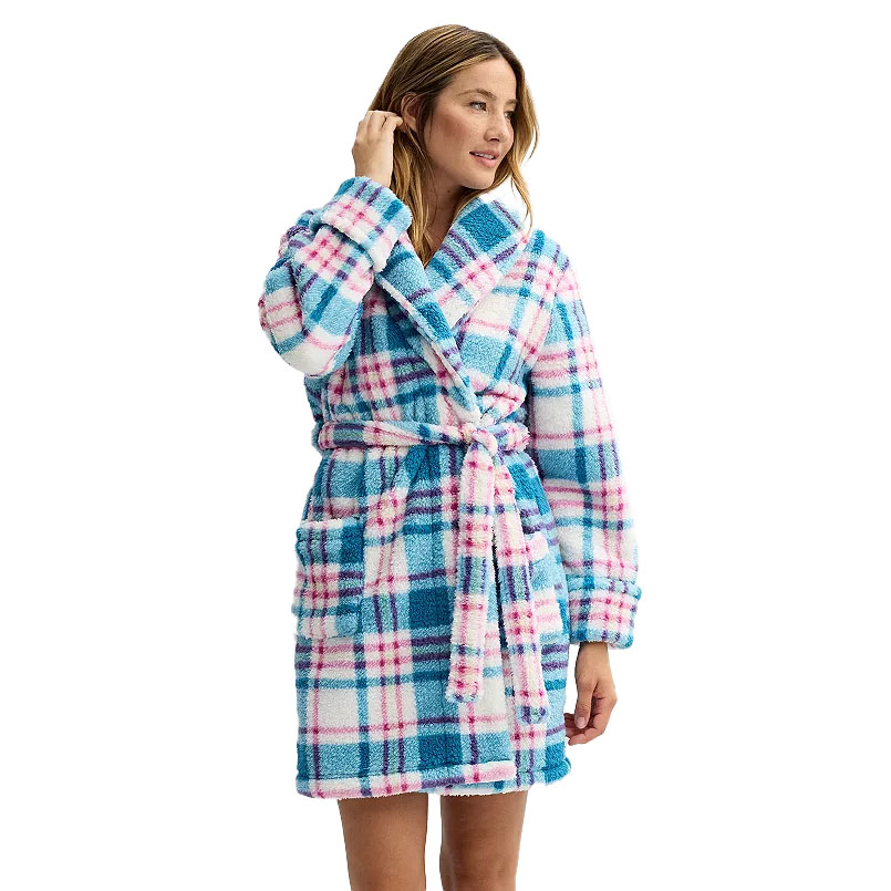 A woman wears a Sonoma plush robe, featuring a pink, blue, and white plaid pattern. The robe includes a shawl collar, a waist tie belt, and front pockets.
