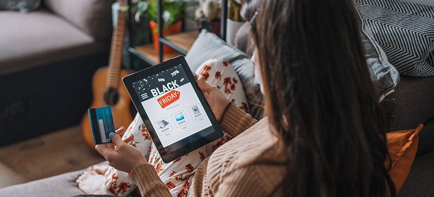 woman on tablet looking at last year's black friday sales