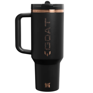 Black insulated travel mug with a large handle, featuring copper accents and the word \“GOAT\“ in a textured design on the side.