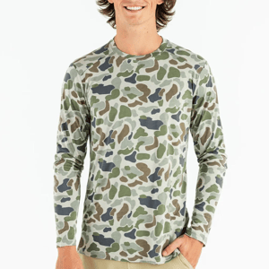 A man wearing a long-sleeved camouflage shirt.