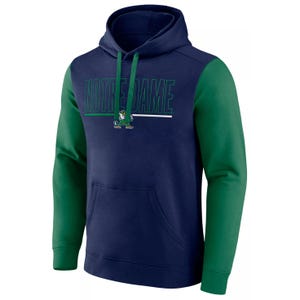 The hoodie is navy with green sleeves and features the text \“Notre Dame\“ along with a leprechaun mascot on the front. It has a front pocket and green drawstrings.