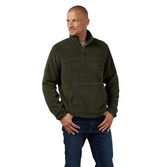 A man is wearing a dark green quarter-zip fleece pullover with a high collar and a kangaroo pocket, paired with dark blue jeans.