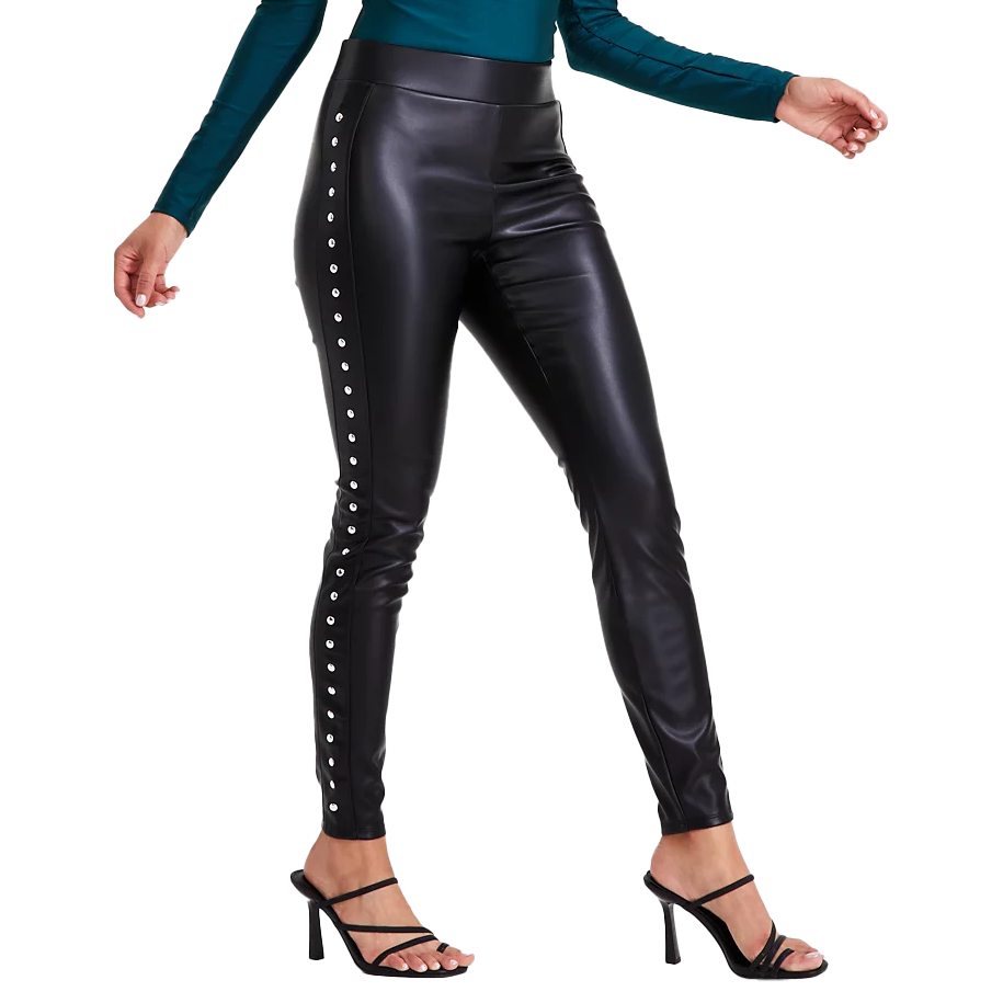 Black faux-leather leggings with side stud detailing, featuring a high-waisted fit. Pairing with strappy black heels and a teal long-sleeve top, they offer a sleek and stylish look.