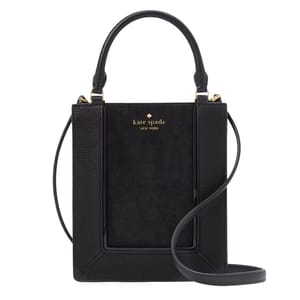 A black Kate Spade mini tote with a suede texture, featuring top handles, a gold-tone logo on the front, and a detachable shoulder strap.